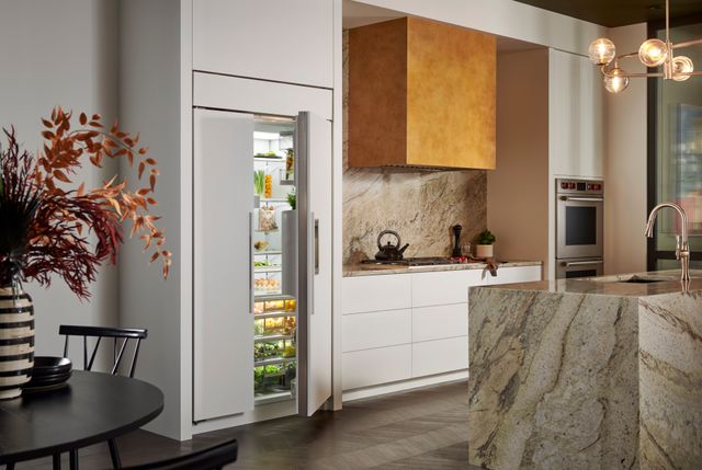 Front view of a luxury kitchen with a built in panel ready Sub-Zero panel ready refrigerator