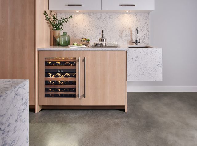 Credit: Sub-Zero Front view of a modern bar area with an under counter wine refrigerator from Sub-Zero