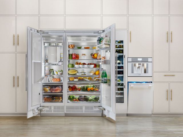 Front view of a modern kitchen wall with opened Thermador refrigerators