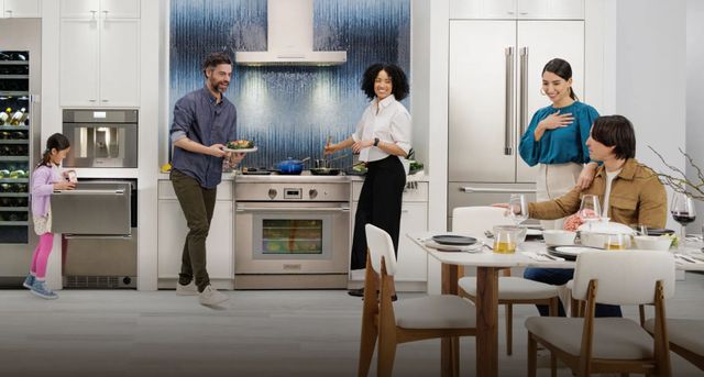 Credit: Thermador Front view of a family having dinner using their Thermador kitchen appliances