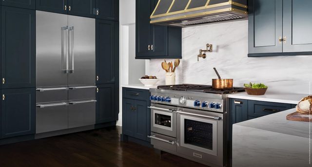 Credit: Thermador Front view of a luxury kitchen with a Thermador range, range hood, and refrigerator