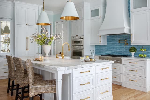 Front view of a luxury kitchen with a Thermador cooktop and range hood