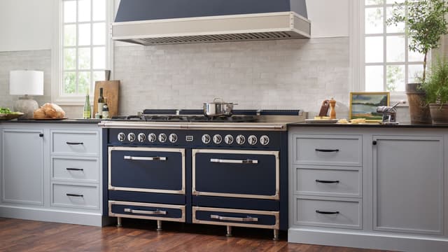 Front view of a modern kitchen with a custom Viking range and range hood Front view of a modern kitchen with a custom Viking range and range hood