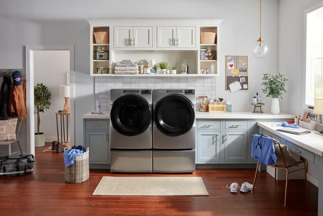 Front view of a modern laundry room with a Whirlpool washer and dryer Front view of a modern laundry room with a Whirlpool washer and dryer