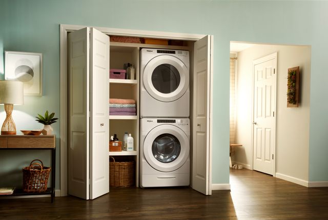 Credit: Whirlpool Front view of a laundry closet with a Whirlpool stacked front load washer and dryer