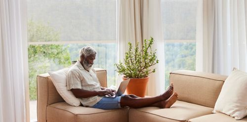 Blinds in Living Room Man Relaxing with Automatic Blinds
