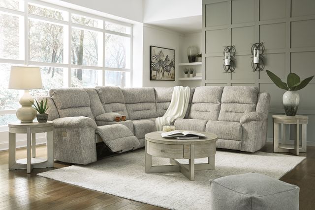 Front view of a modern living room with a grey sectional recliner