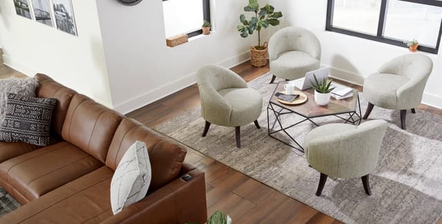 Front view of a modern home with a sofa and four accent chairs around a table Front view of a modern home with a sofa and four accent chairs around a table