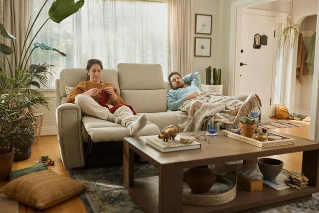 Front view of a modern living room with two people relaxing on a La-Z-Boy sofa