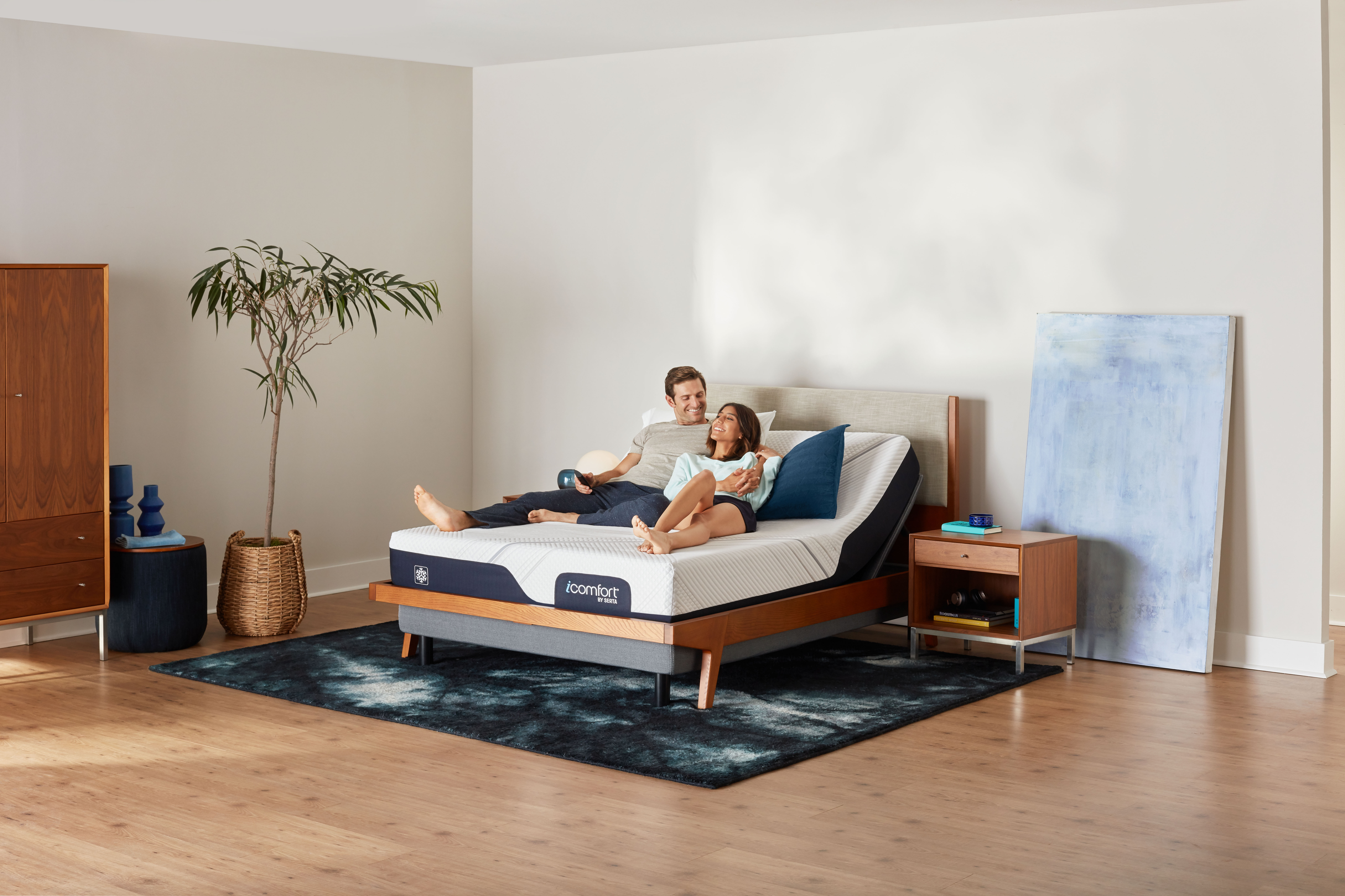 Couple relaxing on a Serta adjustable bed foundation
