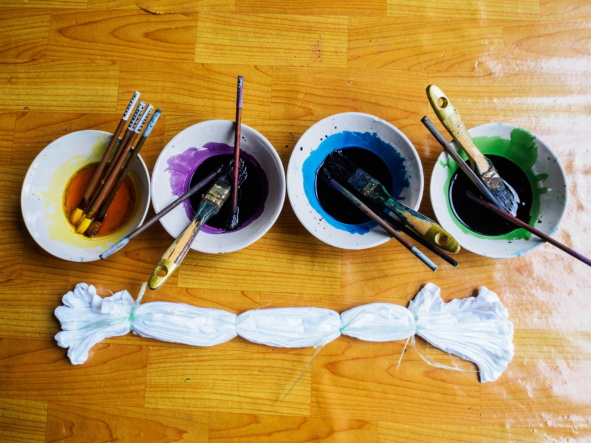a line of tie-dye paints and a rubber-banded t-shirt