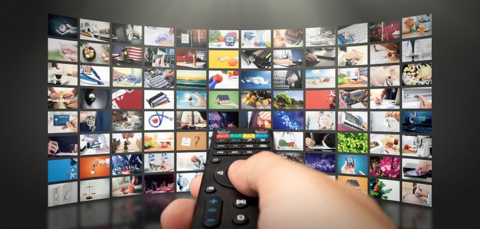 collage of different streaming programs with handheld remote in foreground