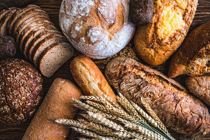 assortment of breads on rustic wooden table
