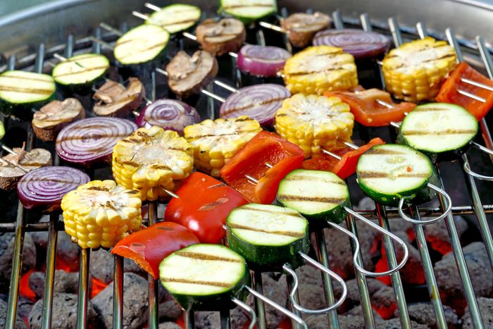 mixed vegetable skewers on a charcoal grill