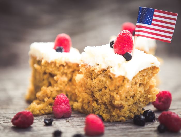 carrot cake with cream cheese frosting and raspberries and blueberries