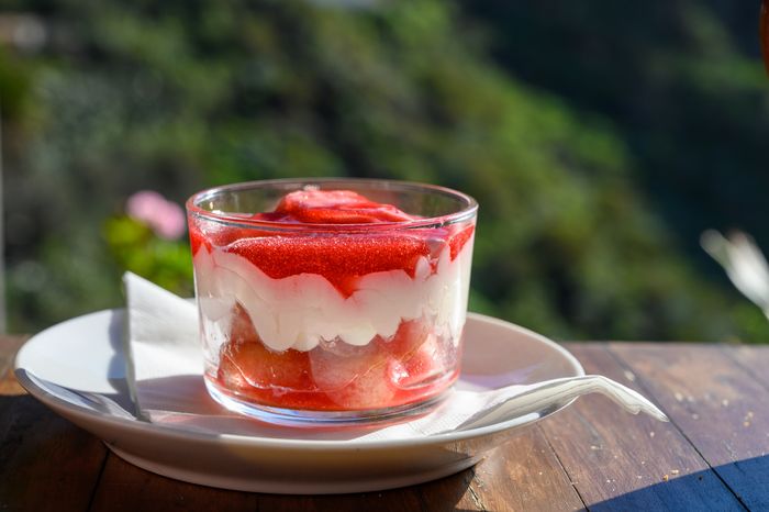 cheesecake with mousse and red prickly-pear jam served in glass