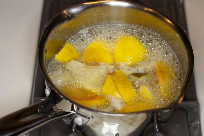 a boiling pot of cut up lemons, grapefruits, and lime pieces in some water