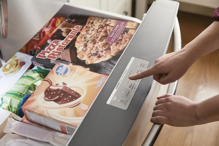 An open Custom-Flex Temp Drawer with a woman's hand reaching out to change the temperature setting.
