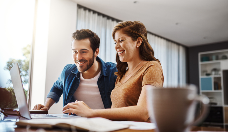A young couple support local business online from their home