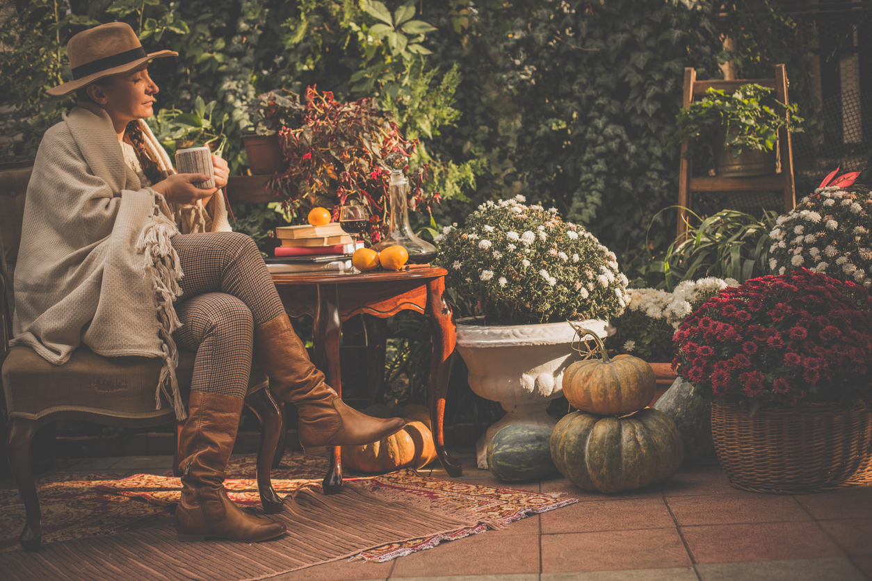 woman sitting outside in patio area during fall time