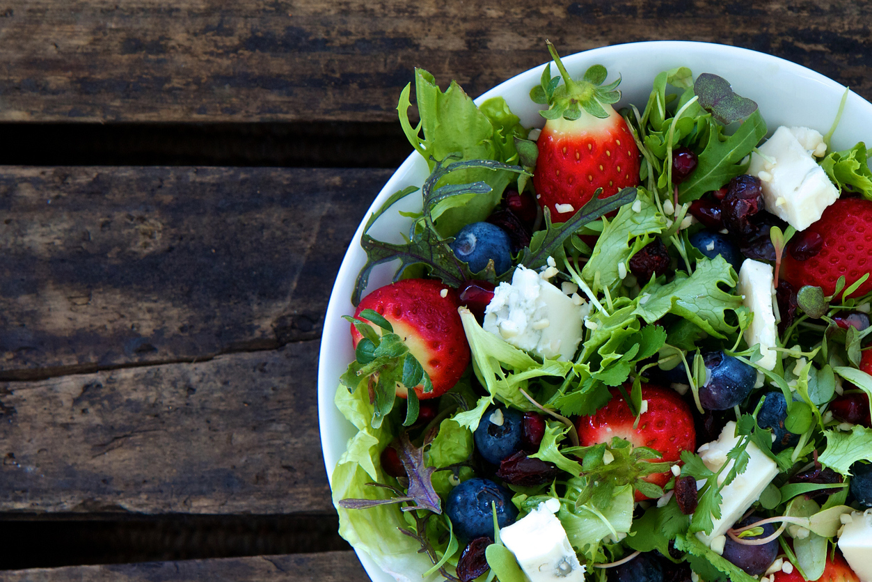 strawberry blueberry salad in white bowl