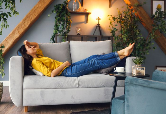woman lounges on an entire loveseat