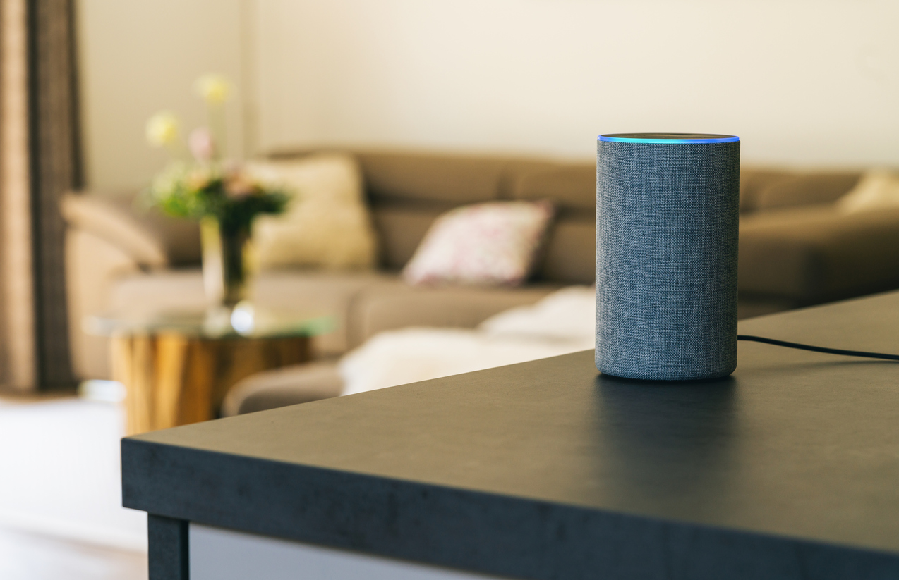voice control amazon echo on a table in a living room 