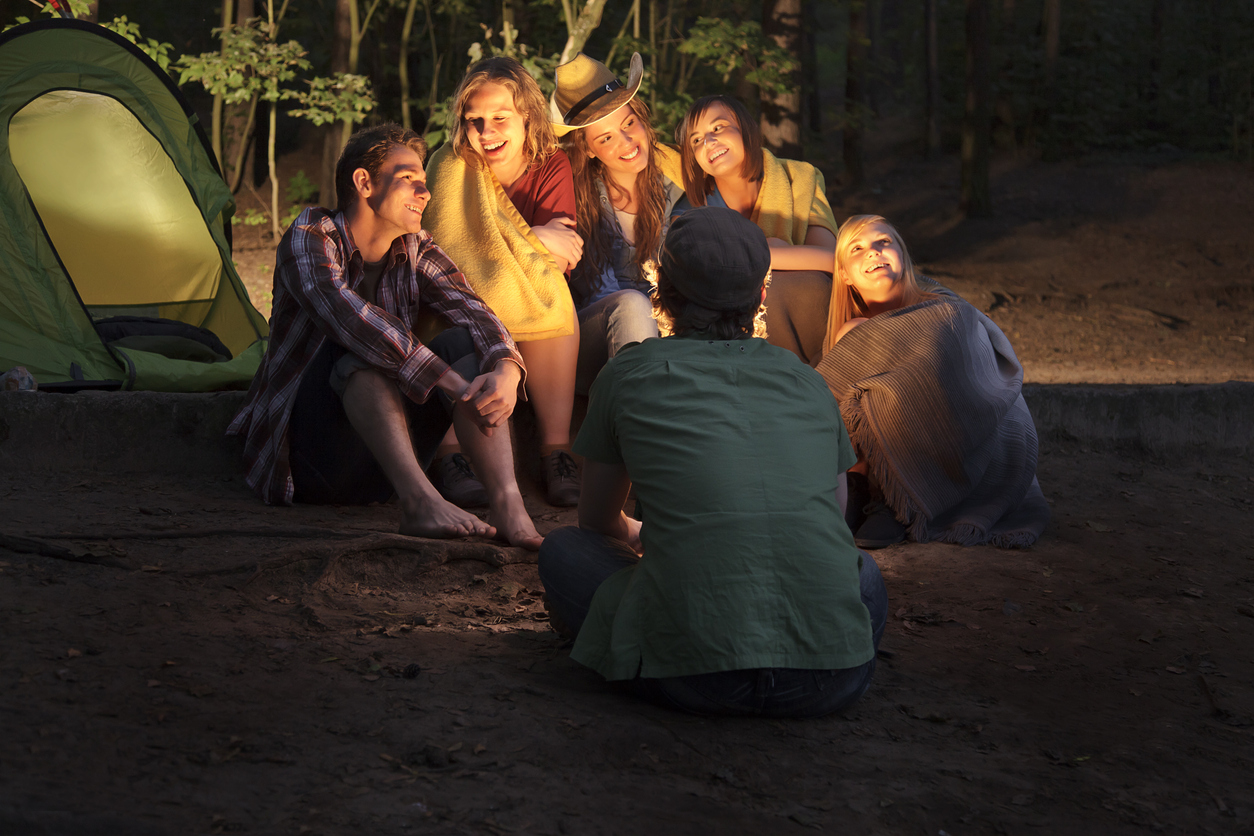 friends sitting around a campfire listening to a story