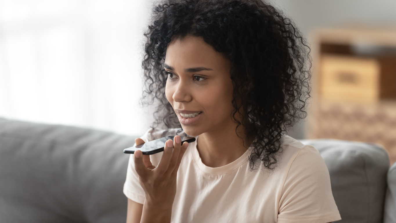 woman using voice search through her smart phone