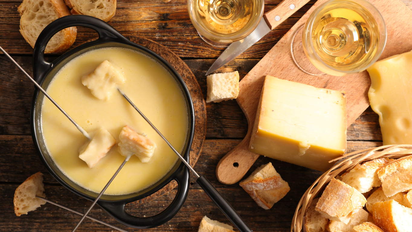dipping bread in fondue pot