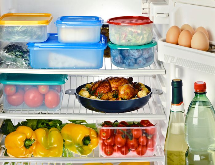 The inside of a refrigerator full of food and leftovers.