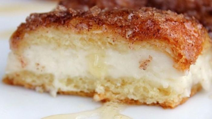 A slice of cheesecake pie, with creamy filling and a flaky, cinnamon crust.