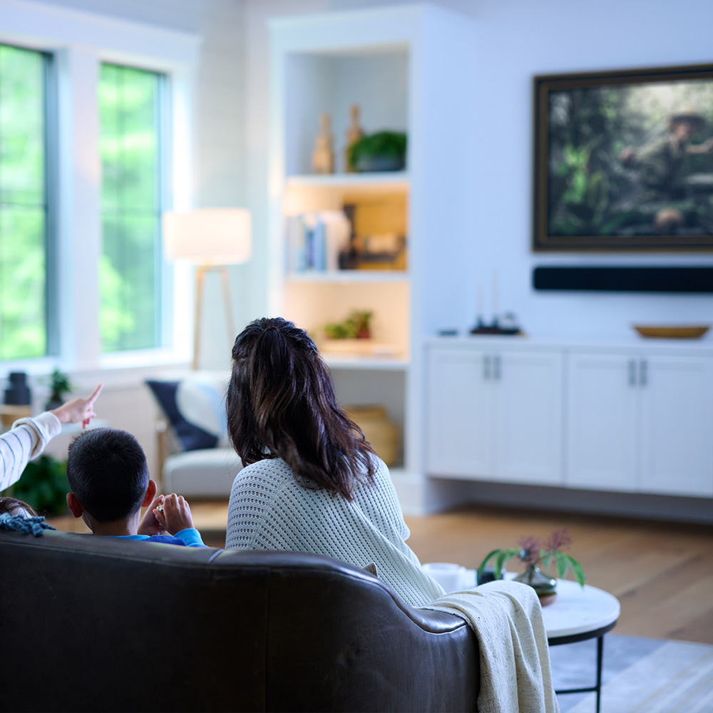 Family watching TV in living room