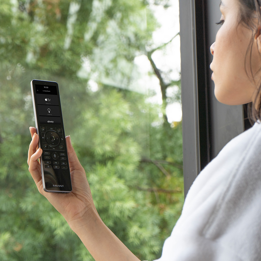 Woman holding remote control controlling door lock
