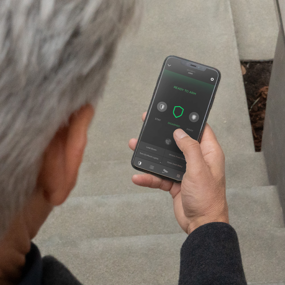 Man holding smart phone with security icon on screen
