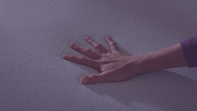 hand pressing into memory foam