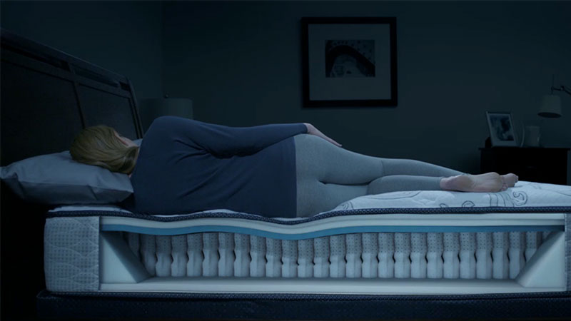 woman sleeping in bed with back support