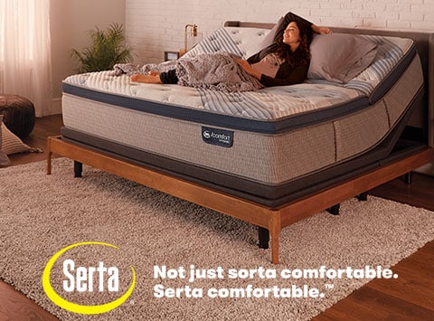 Serta Mattress bedroom woman happy laying in bed. Not just sorta comfortable. Serta Comfortable ™