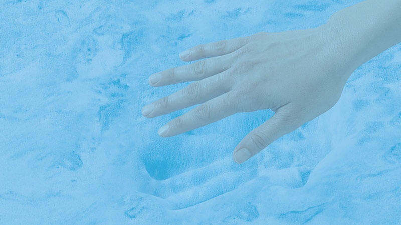 hand pressing into mattress