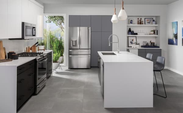 Stylish kitchen featuring a stainless steel GE Profile 4-french-door refrigerator