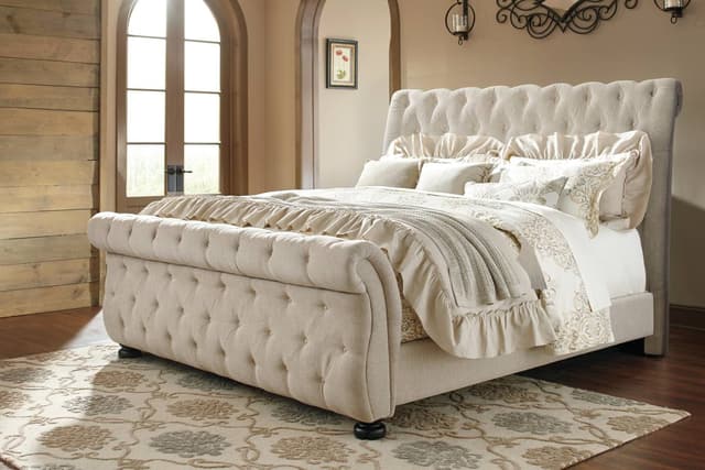 front view of a cream upholstered king sleigh bed