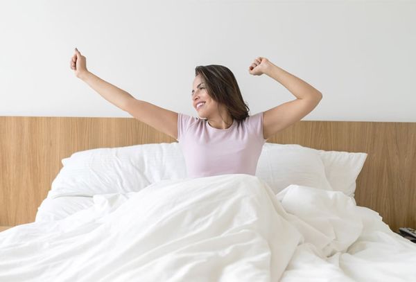 person waking up in a comfy bed