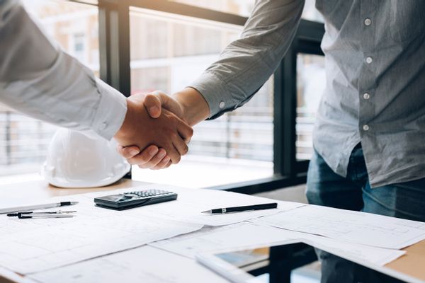 Men shaking hands over a project