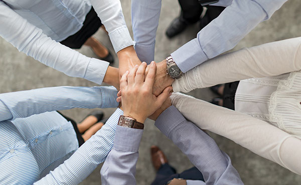 Team with hands together