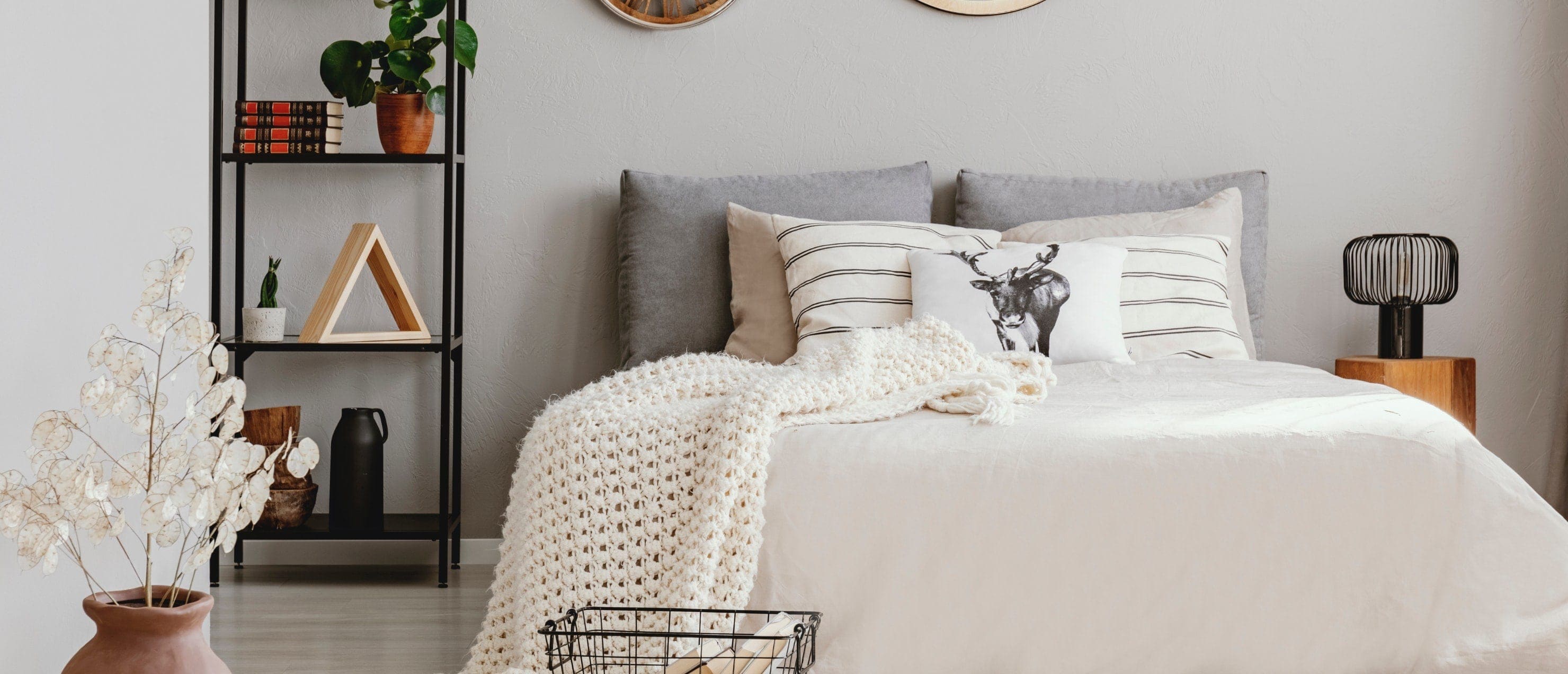 Comfortable, bright bedroom with throw blanket