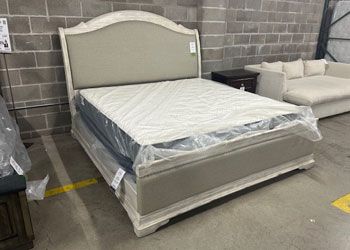 Beige/gray upholstered panel bed.