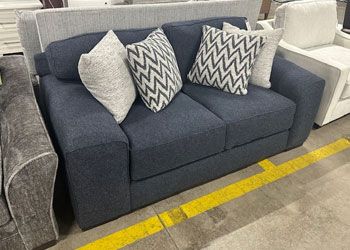 Blue loveseat with throw pillows
