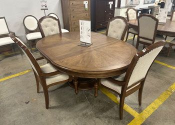 Wood dining room set with 4 beige upholstered chairs.