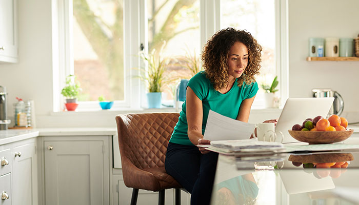 Woman sitting at the table with papers in her hands