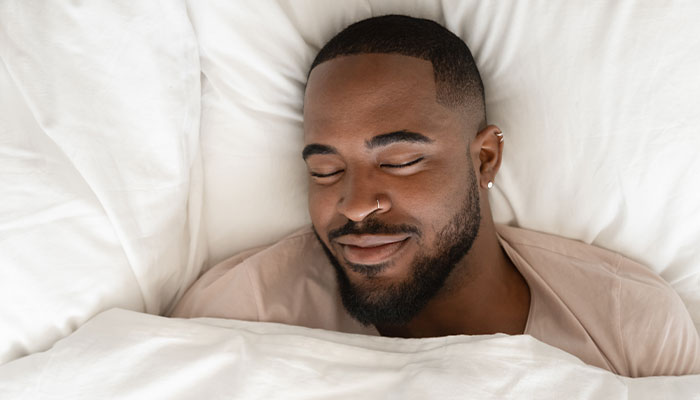 Man sleeping peacefully on a comfortable new mattress